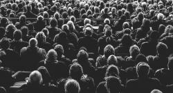 Black and white photo of a crowd from behind