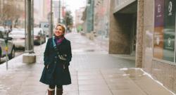 Latina smiling, walking on street in winter