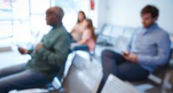 Defocused image of people sitting in an agency waiting room