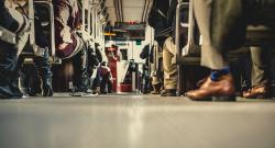 Feet of people sitting on a bus, from a low angle