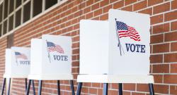 Three empty voting booths outside