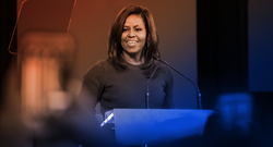 Michelle Obama speaking at a podium