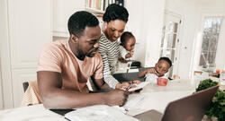 Black Family Around the Table Paying Bills