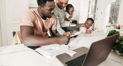 Black Family Around the Table Paying Bills