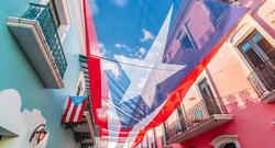 Large flag of Puerto Rico above the street in the city center of San Juan.