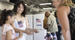 A diverse group of people voting at the local community center