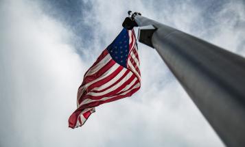Looking up a flagpole at the U.S. flag