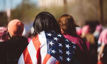 Person wrapped in American flag