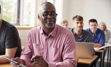Classroom of older students with Black student at the forefront