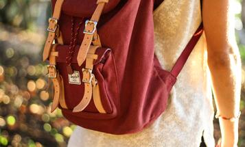 College student wearing a red backpack
