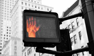 Don't cross orange hand on a cross walk sign