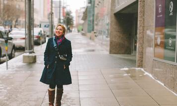 Latina smiling, walking on street in winter