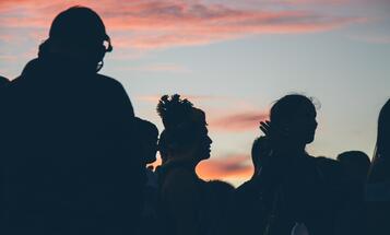 Group of people backlit at sunset