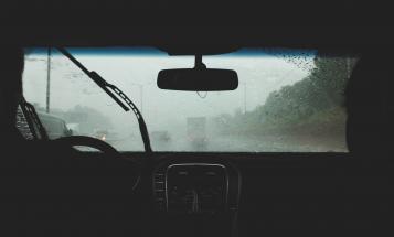 View of front windshield of car from back seat