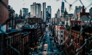 View of a New York street and buildings through chain link fence
