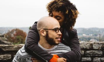 A couple of color embracing in the fall