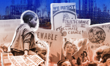 Smiling Black boy sitting on his father's shoulders as they walk through a climate crisis protest