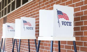 Three empty voting booths outside