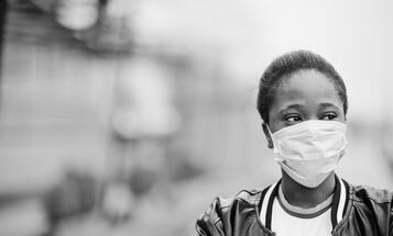 Black woman wearing a surgical face mask during the COVID-19 pandemic