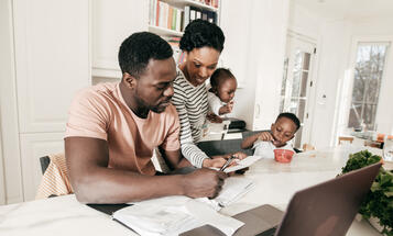 Black Family Around the Table Paying Bills