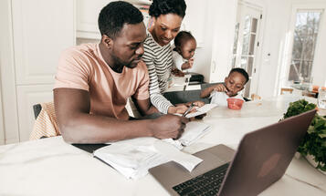 Black Family Around the Table Paying Bills