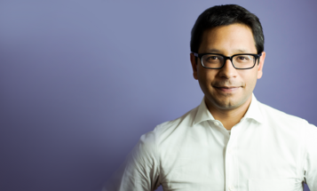 K. Sabeel Rahman standing against purple background