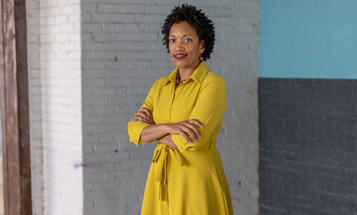Taifa Smith Butler standing with arms crossed