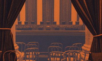 View of Supreme Court justices seats from the gallery with seats and a curtain in foreground