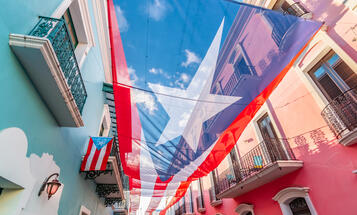 Large flag of Puerto Rico above the street in the city center of San Juan.