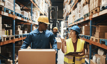 Workers walking and talking in a warehouse