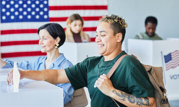 Multiracial Voters Putting Ballots in Bin