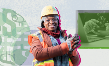 Black construction worker smiling at the camera with hands clasped