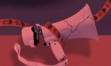 A broken megaphone wrapped in red tape that is dotted with I Voted stickers