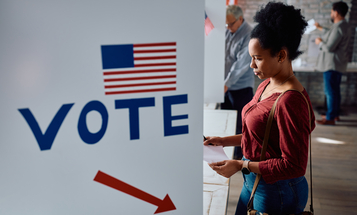 Black woman standing at a voting booth