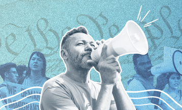 Organizer with a bull horn in front of a rally line