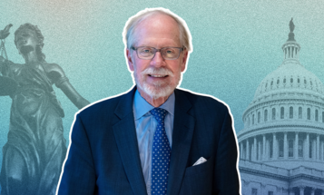 Stephen Heintz in a suit and tie stands in front of an illustrated background featuring the Statue of Justice and the U.S. Capitol building.