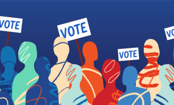 Illustration of a crowd holding "Vote" signs against a solid blue background.