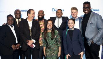 Group of people on stage at Demos conference