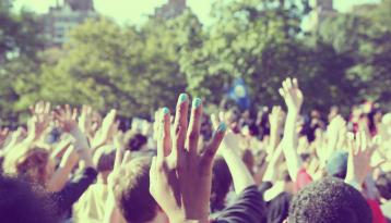 Give Now, Crowd with hands raised