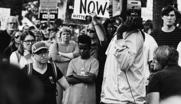 Crowd with Justice Now sign