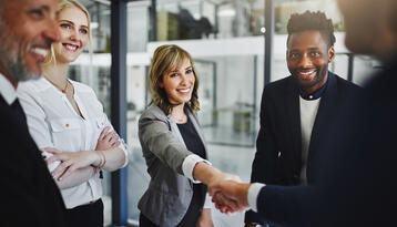 Group of workers greeting an interview job applicant 