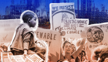 Smiling Black boy sitting on his father's shoulders as they walk through a climate crisis protest