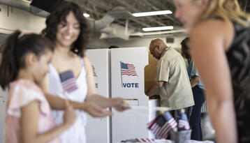 A diverse group of people voting at the local community center