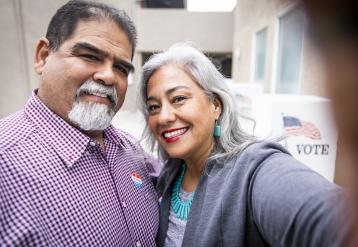 Smiling Latino couple who just voted