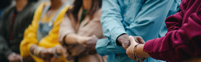 Multiracial group holding hands