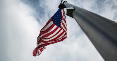 Looking up a flagpole at the U.S. flag