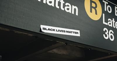 Black Lives Matter sticker on MTA subway sign