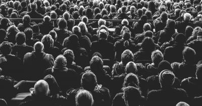 Black and white photo of a crowd from behind