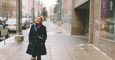 Latina smiling, walking on street in winter