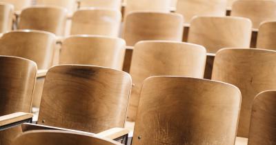 Empty seats in a classroom lecture hall at an angle